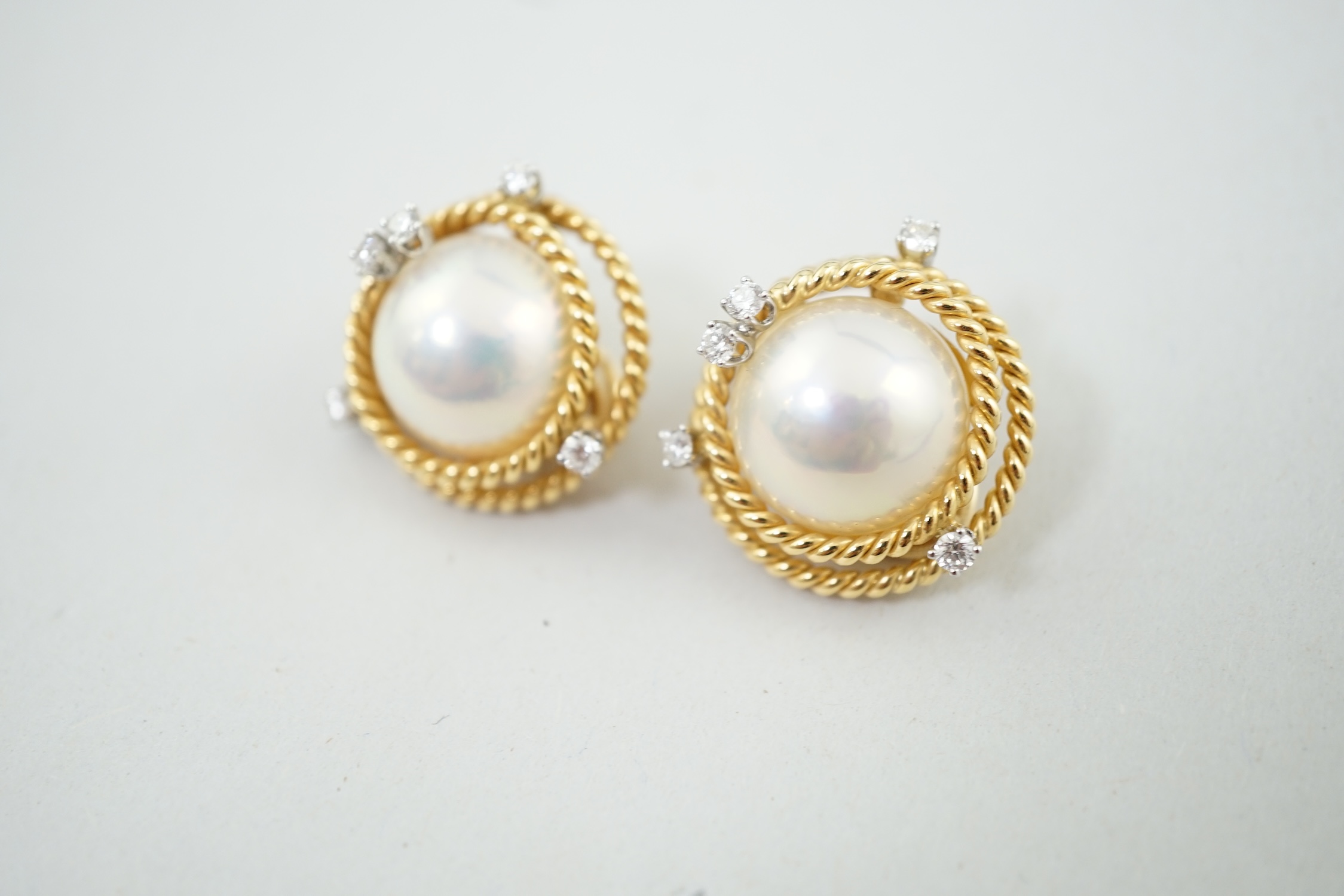 A modern pair of Tiffany & Co Schlumberger Studios 18k gold, mabe pearl and five stone diamond set ear clips